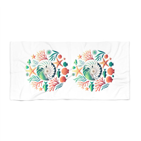 A white rectangular towel featuring two identical circular underwater-themed prints with seashells, starfish, coral, and sea plants in green, orange, and blue.