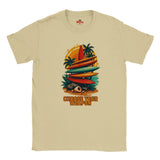 Sand t-shirt with a graphic of surfboards and palm trees and the text 'Choose Your Weapon' on a white background.
