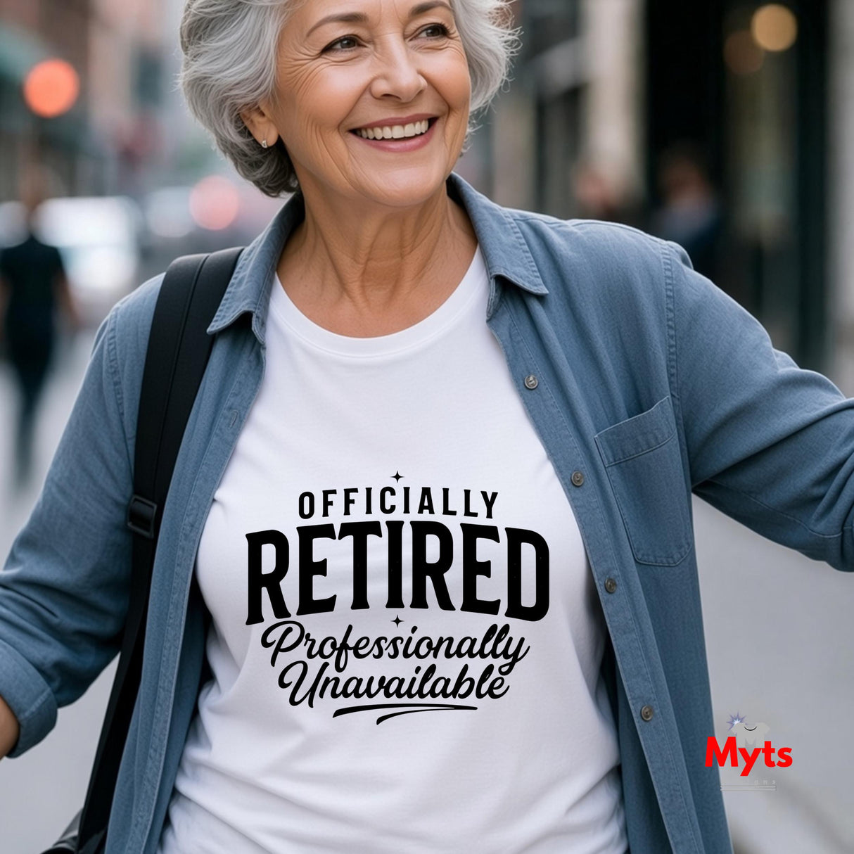 Woman wearing a white funny retirement T-shirt featuring “Officially Retired – Professionally Unavailable” in bold black typography.
