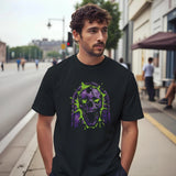 A man wearing a black t-shirt with a purple and green skull design on a city street.