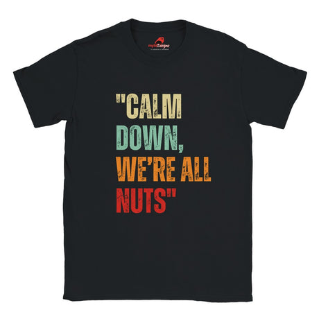 A flat lay view of a black retro styled t-shirt, featuring distressed lettering "Calm Down, We're All Nuts" on a white background