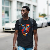 Man wearing a black t-shirt with a colorful face design on a street.
