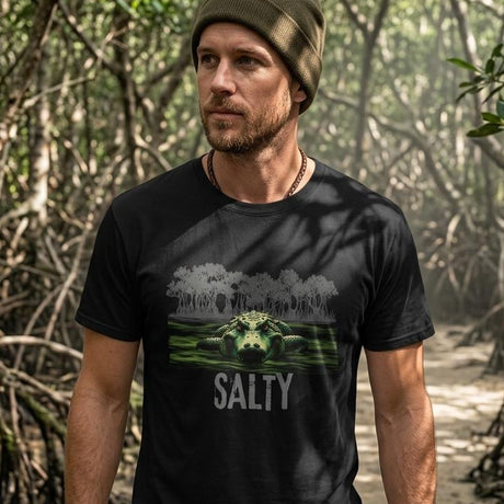 Man wearing a black t-shirt with a graphic design and the word 'Salty' in a forest setting