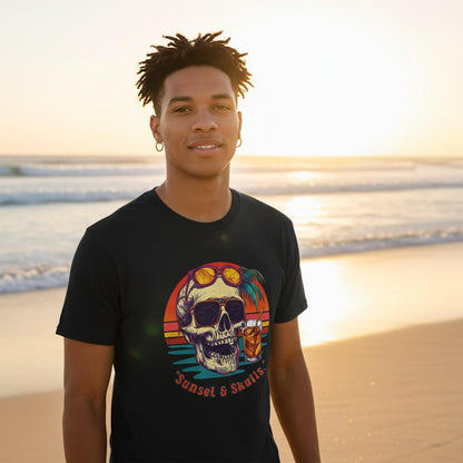Person wearing a black t-shirt with a colorful skull design on a beach at sunset.
