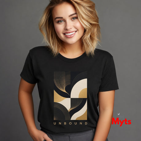 A woman with blonde hair wearing a black crewneck t-shirt with a modern abstract geometric graphic in black, beige, and gold, featuring the word 'UNBOUND' printed below the design. She is posing against a solid dark gray studio background.