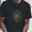 Man wearing a black t-shirt with a colorful geometric design, standing against a neutral background.