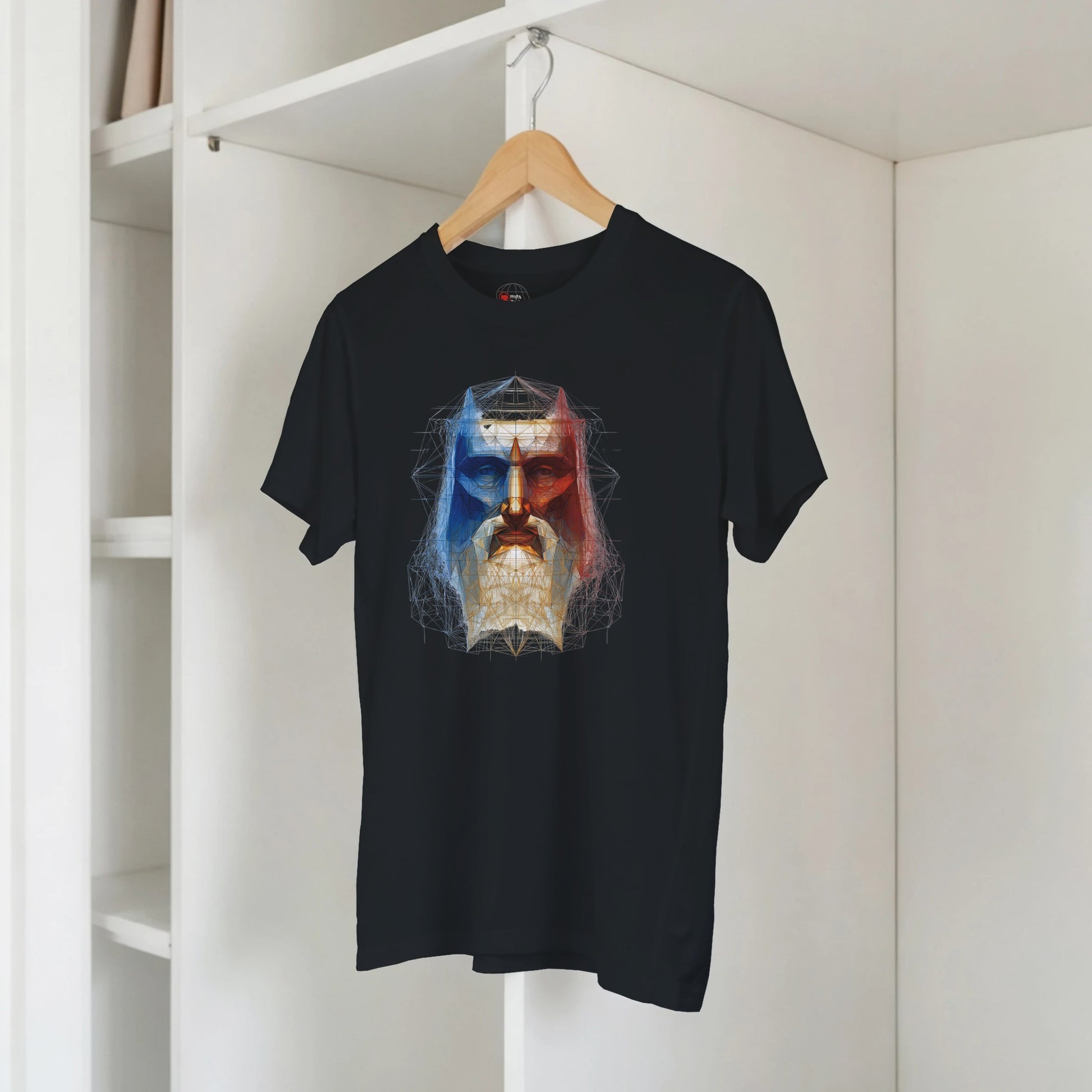 Black t-shirt with a colorful graphic design on a hanger against a white wall.