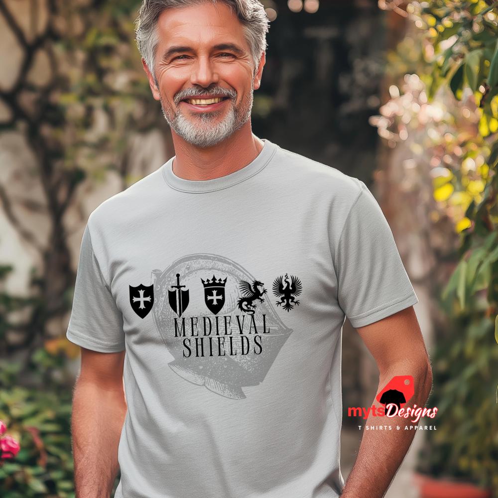 Man wearing a grey t-shirt with medieval shield emblems and knight’s helmet graphic, designed for history lovers and fantasy enthusiasts.