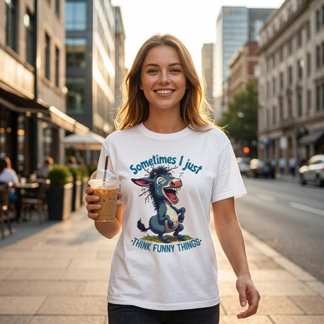 Woman wearing a t-shirt with a cartoon donkey design and text, standing on a city street.