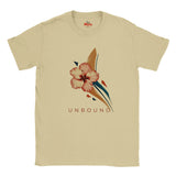 Sand-coloured UNBOUND hibiscus T-shirt with delicate pink floral illustration and geometric navy and beige accents.