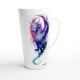 A white ceramic latte mug featuring a colorful watercolor-style illustration of a horned fantasy creature in shades of blue, purple, and pink, with the brand name 'nymphs art' printed near the base.
