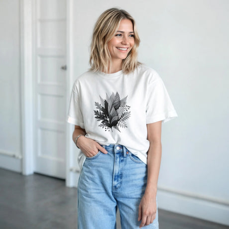 Woman wearing a white t-shirt with a graphic and text, standing indoors.
