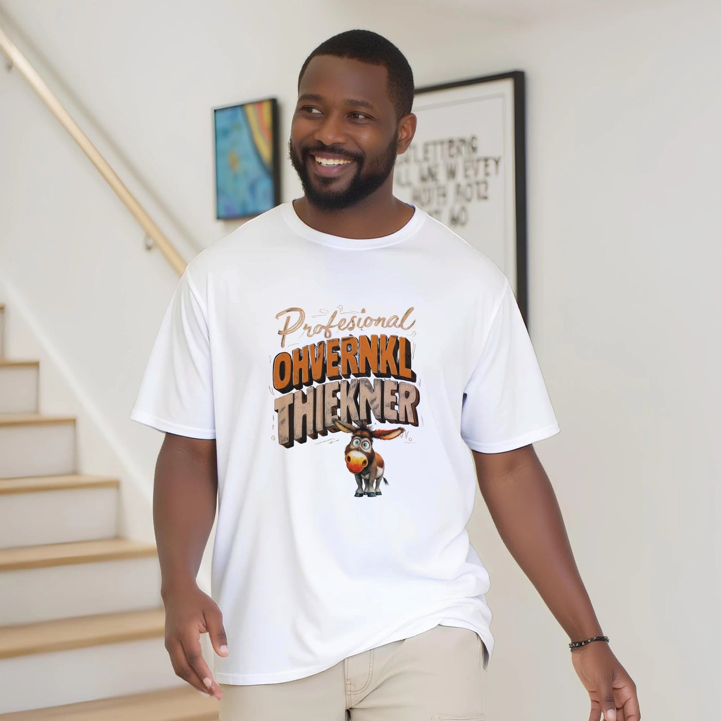 Man wearing a white t-shirt with a graphic design and text, standing indoors.