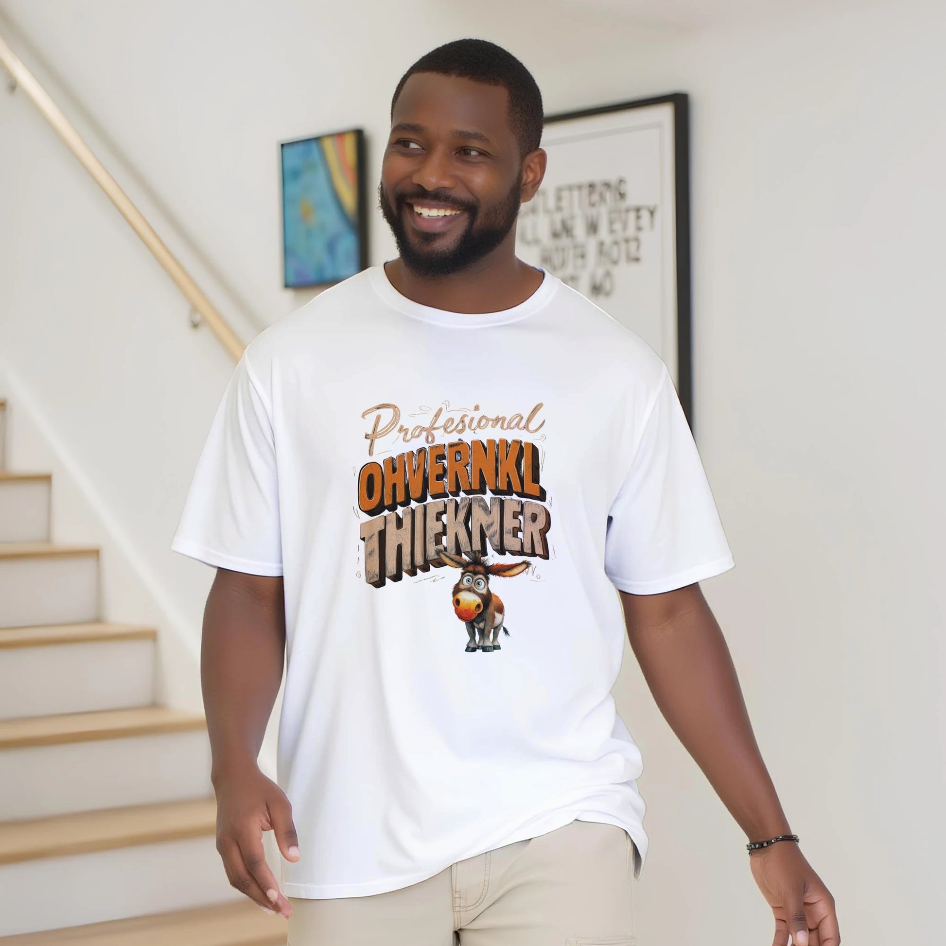 Man wearing a white t-shirt with a graphic design and text, standing indoors.