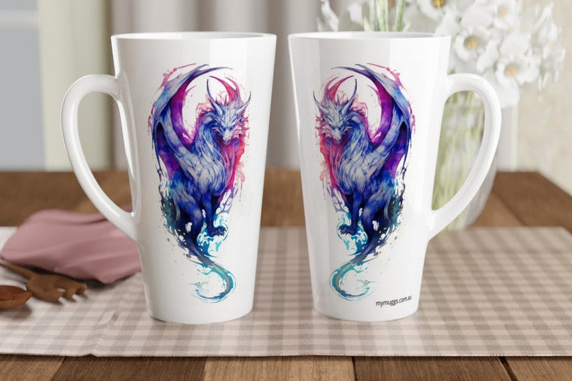 Two tall white ceramic mugs with handles, featuring a colorful watercolor-style dragon design in blue, purple, and pink, displayed on a checkered placemat over a wooden table.