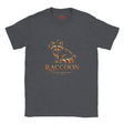 A dark heather gray crewneck t-shirt featuring a stylized orange and brown raccoon graphic with the word 'RACCOON' and the phrase 'FOLLOW YOUR NATURE' printed on the front.