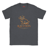 A dark heather gray crewneck t-shirt featuring a stylized orange and brown raccoon graphic with the word 'RACCOON' and the phrase 'FOLLOW YOUR NATURE' printed on the front.