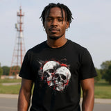 A man wearing a black t-shirt with a skull design outdoors