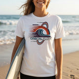 Person wearing a white t-shirt with 'Orbital Flow' design on a beach