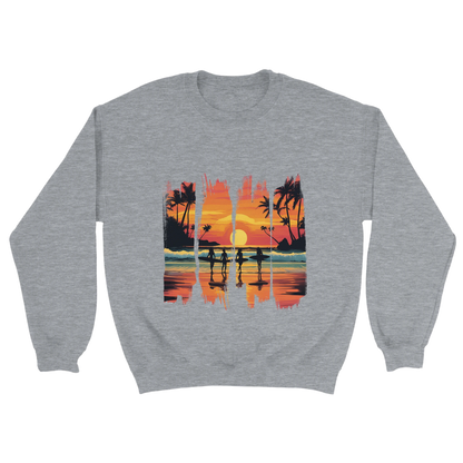 A grey unisex sweatshirt featuring a vibrant tropical sunset design with silhouettes of surfers walking along a beach. The graphic includes palm trees, an orange and pink sky, and artistic brushstroke edges, creating a modern coastal vibe. Ideal for beach lovers, surfers, and casual fashion fans.

