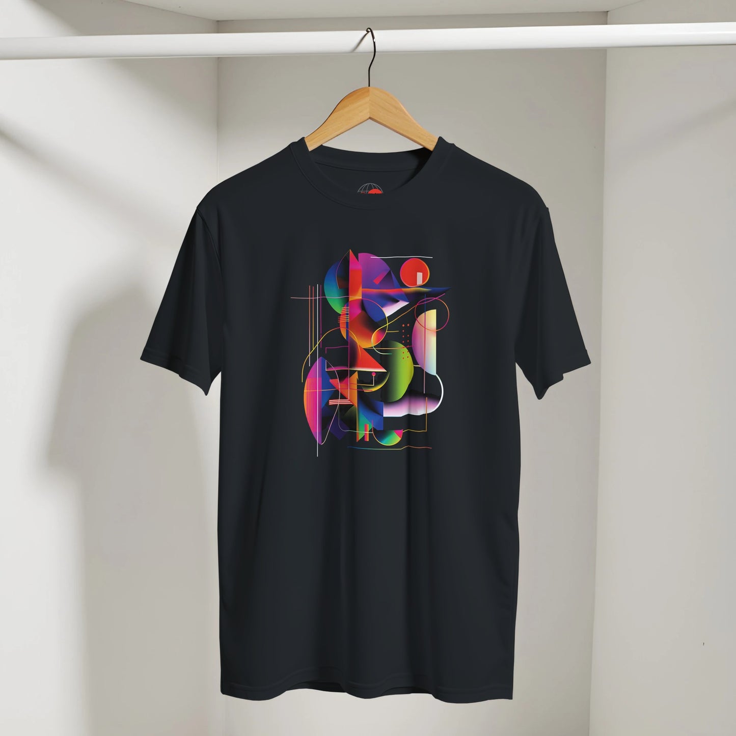 Black t-shirt with colorful geometric design on a hanger against a neutral background