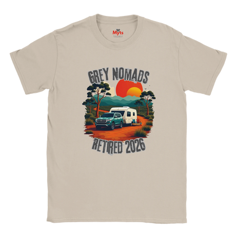 A Sand crewneck t-shirt featuring a retro-style graphic of a green pickup truck towing a white camper on an orange dirt road, with a red and orange sunset and the text 'GREY NOMADS RETIRED 2026'. The inner collar shows the 'Myts' brand logo.
