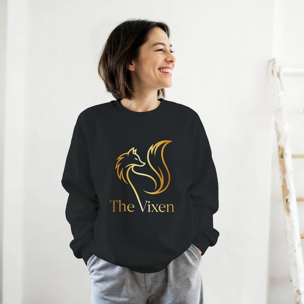 Person wearing a black sweatshirt with graphic design against a white background