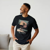 A male model wearing a black "The Beach" T-shirt