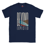 A navy blue short-sleeve t-shirt with a graphic print on the front reading 'BEYOND EXPECTED' in white, featuring a stylized surfboard design in cream, orange, teal, and red.