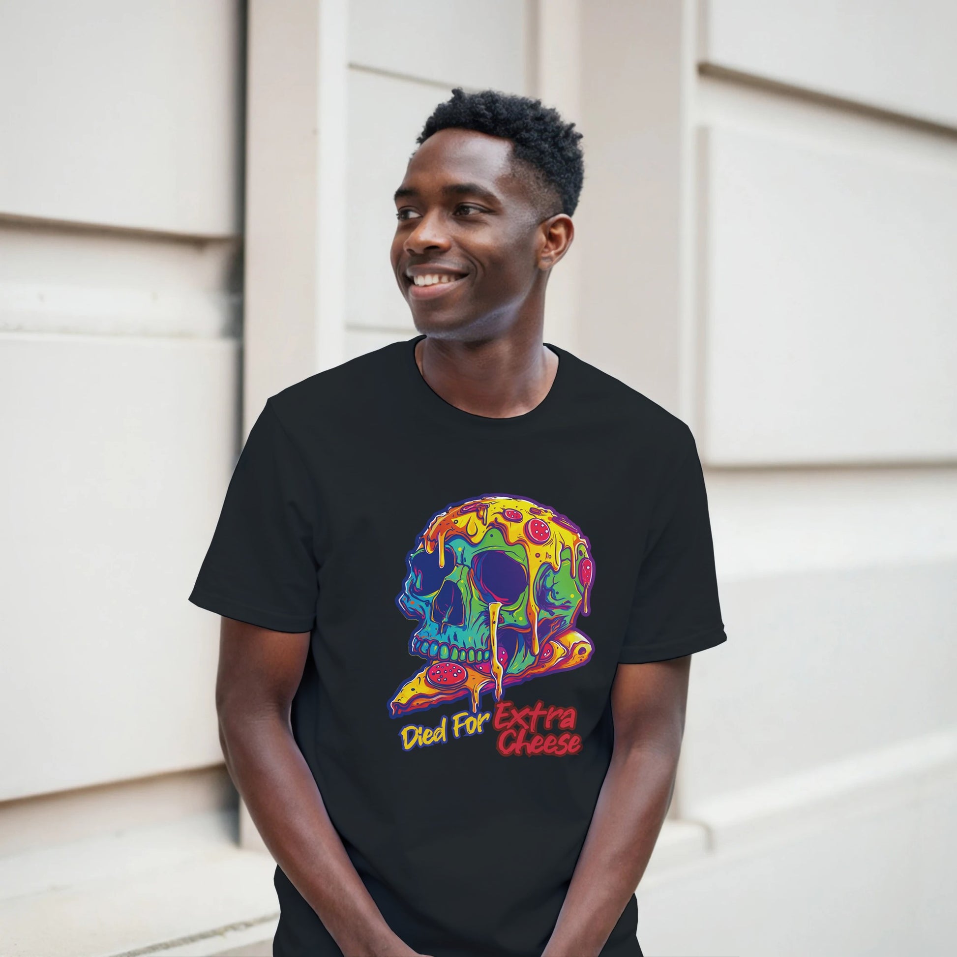 Man wearing a black t-shirt with a colorful skull design and text.