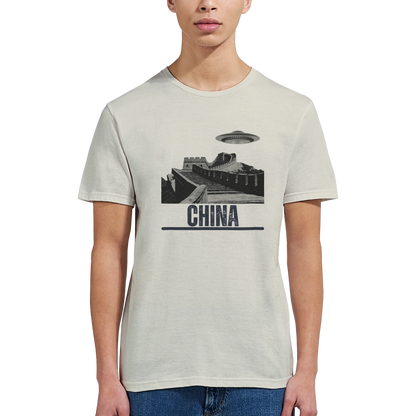 “Woman wearing a white T-shirt with a vintage black-and-white Great Wall of China illustration and a UFO hovering above it, labeled ‘CHINA,’ designed by MytsDesigns.com in a gym setting”

