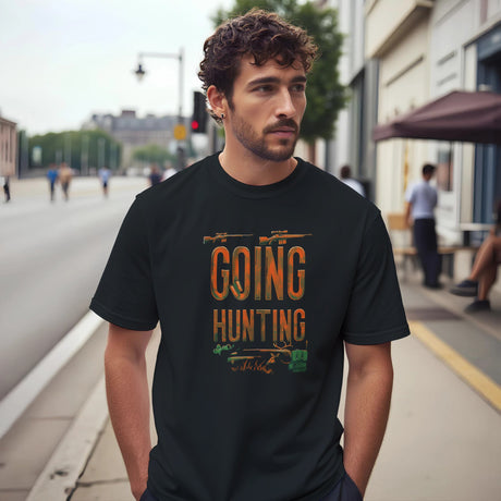 Man wearing a black t-shirt with 'Going Hunting' text on a city street.