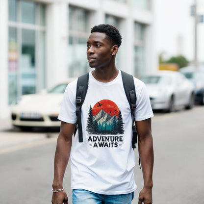 A man wearing a white t-shirt with the 'Adventure Awaits' graphic is walking on a street.