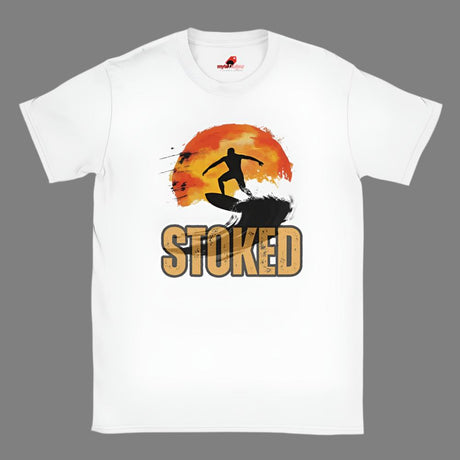 A white crew neck t-shirt with a graphic print of a surfer silhouette and the word 'STOKED' in bold lettering, set against a sunset background.