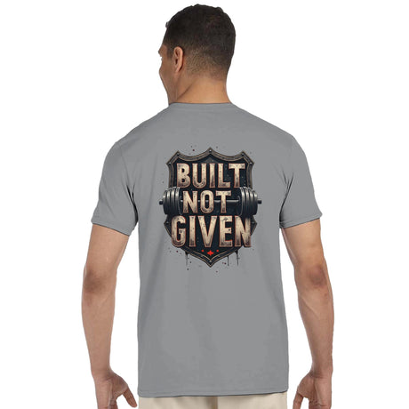 Man wearing a gray t-shirt with 'Built Not Given' design on the back