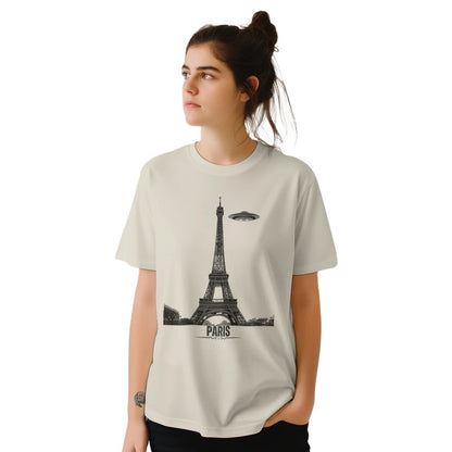 Front view of a Sand coloued soft casual tee featuring a whimsical graphic of the Eiffel Tower with a retro‑style spaceship orbiting it, worn by a young woman.