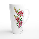 A tall white ceramic latte mug featuring a detailed botanical illustration of pink and white lilies with green leaves, shown on a clean white background.