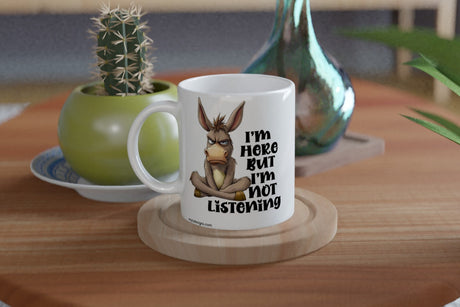 Funny “I’m Here But I’m Not Listening” donkey mug. Perfect sarcastic gift for coworkers, coffee lovers, and anyone sick of small talk. 11oz ceramic, Aussie-made.