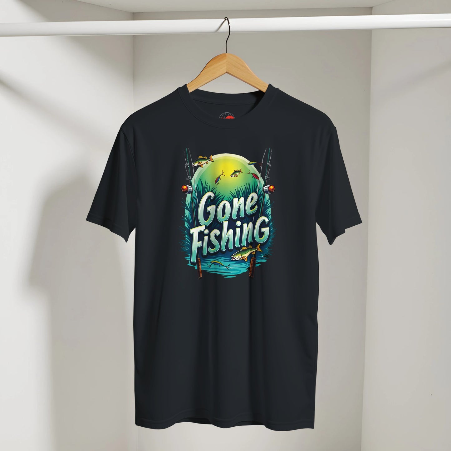 Black t-shirt with 'Gone Fishing' graphic on a hanger against a white wall