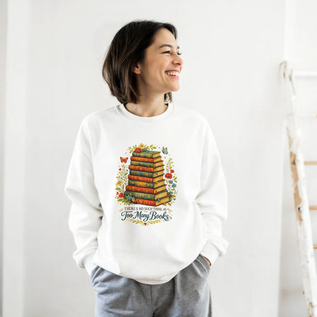 Person wearing a white sweatshirt with a colorful book-themed design on a plain background