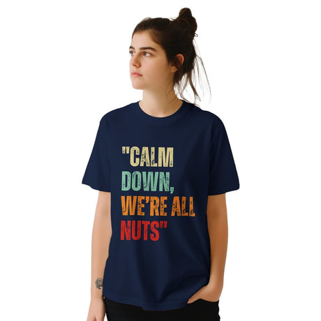 girl wearing A navy retro styled t-shirt, featuring distressed lettering "Calm Down, We're All Nuts" on a white background