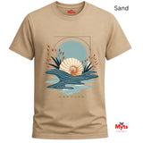 A Sand unisex coastal graphic tee with minimalist seashell, abstract blue ocean waves, and UNBOUND lettering.