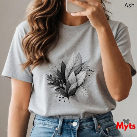 Person wearing a gray t-shirt with leaf design, taking a mirror selfie.