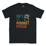 Front view of a casual tee featuring retro script that reads “Dibs on Funniest Psycho” in distressed vintage style, printed on ultra-soft black Gildan 64000 cotton