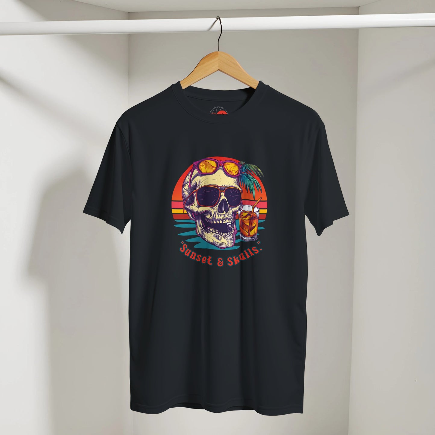 Black t-shirt with colorful skull design on a hanger against a white wall
