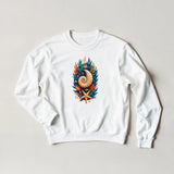 A white crewneck sweatshirt with a colorful nautical graphic on the chest, featuring a nautilus shell, blue leaves, and an orange starfish, laid flat on a light beige background.