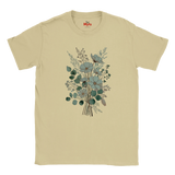 A beige short-sleeve crewneck t-shirt featuring a central graphic print of a floral bouquet with blue-gray flowers and green leaves, displayed on a clean white background.