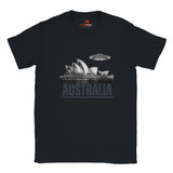 Front view of a black soft casual tee showing the Sydney Opera House sails with a sleek spaceship graphic orbiting overhead, printed on ultra-soft Gildan 64000 cotton.