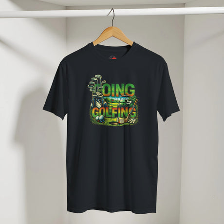 Black t-shirt with colorful golf-themed design on a hanger against a white wall.