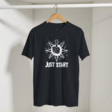 Black t-shirt with white graphic and 'JUST START' text on a hanger against a neutral background